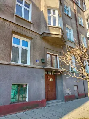a building with a red door on a street at Uroczy apartament w centrum Krakowa in Kraków