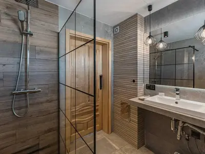 a bathroom with a sink and a shower at Tatra Village in PyzÃ³wka