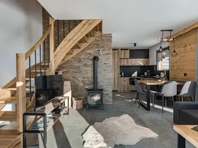 a kitchen and living room with a fireplace and a dining room at Tatra Village in PyzÃ³wka