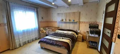 a bedroom with a bed and a large window at Chata u Górala in Stróża