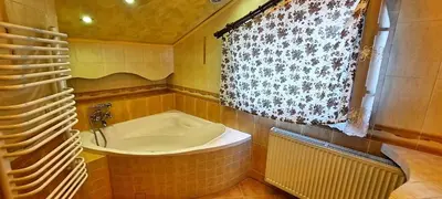 a bathroom with a bath tub and a window at Chata u Górala in Stróża
