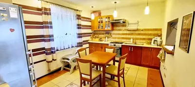 a kitchen with a table and chairs in a kitchen at Chata u Górala in Stróża