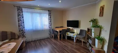 a small living room with a table and a television at Chata u Górala in Stróża