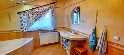 a bathroom with a tub and a sink and a bath tub at Chata u Górala in Stróża