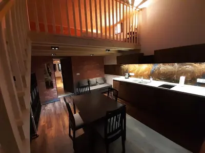 a dining room with a table and a bar at Silent Place in Heart of Krakow near Main Station in Kraków