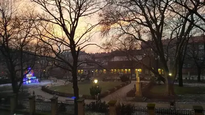 a park at night with a christmas tree in the distance at Silent Place in Heart of Krakow near Main Station in Kraków
