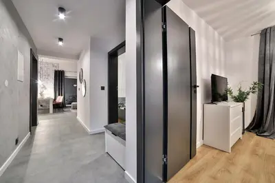 a hallway with a door leading to a living room at Nowoczesne Apartamenty typu Superior - Bulwary Rabka Zdrój - Balia - Blisko Park Zdrojowy in Rabka
