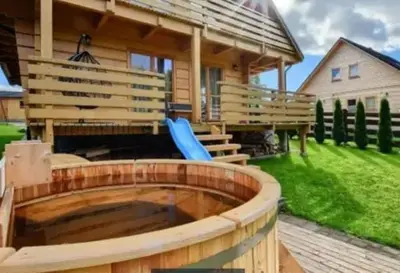 a log cabin with a large pool in the yard at Willa Stryszawka in Stryszawa