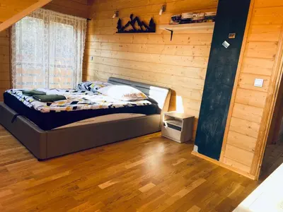 a bedroom with a bed in a wooden room at Willa Stryszawka in Stryszawa