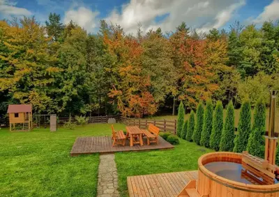 a garden with a picnic table and a fire pit at Willa Stryszawka in Stryszawa