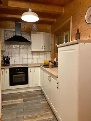 a kitchen with white cabinets and a stove top oven at Willa Stryszawka in Stryszawa