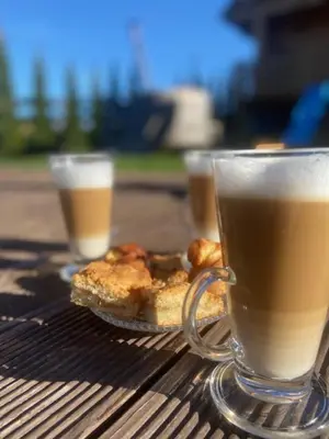 a cup of coffee and some food on a table at Willa Stryszawka in Stryszawa