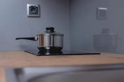 a pot sitting on top of a stove at Modern Studio Cracow Rakowicka 14 by Noclegi Renters in Kraków