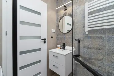 a bathroom with a white sink and a mirror at Modern Studio Cracow Rakowicka 14 by Noclegi Renters in Kraków