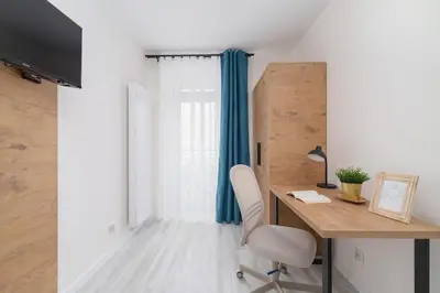 a home office with a desk and a chair at Modern Studio Cracow Rakowicka 14 by Noclegi Renters in Kraków