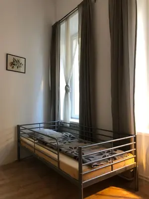 a bed in a room with a window at Caramba in Kraków