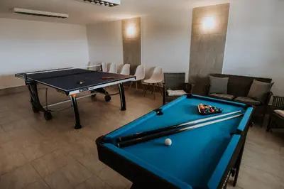 a pool table in a room with a ping pong table at Wzgórze Marzeń in Zembrzyce