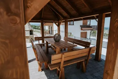 a wooden table and benches on a patio at Wzgórze Marzeń in Zembrzyce
