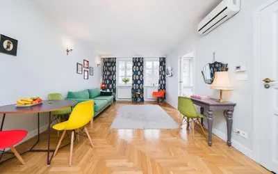a living room with a green couch and yellow chairs at In The Heart Of Jewish Quarter - Old Synagogue - by Upstairs in Kraków