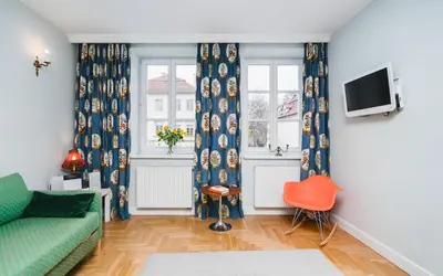 a living room with blue curtains and a green couch at In The Heart Of Jewish Quarter - Old Synagogue - by Upstairs in Kraków