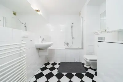 a white bathroom with a sink and a toilet at In The Heart Of Jewish Quarter - Old Synagogue - by Upstairs in Kraków