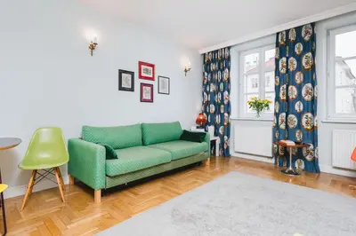 a living room with a green couch and a window at In The Heart Of Jewish Quarter - Old Synagogue - by Upstairs in Kraków