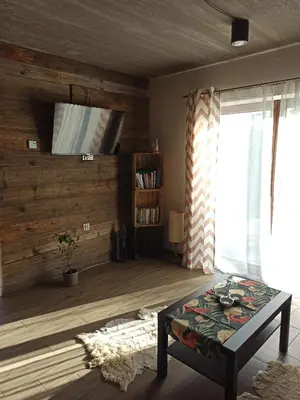 a living room with a couch and a coffee table at KOCIA GÓRA in Chomranice