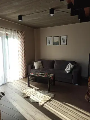 a living room with a couch and a table at KOCIA GÓRA in Chomranice