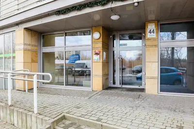 an entrance to a building with revolving doors at Dzielnica XIII Podgórze Kraków by Noclegi Renters in Kraków