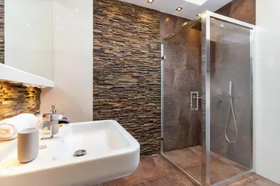 a bathroom with a sink and a shower at Dzielnica XIII Podgórze Kraków by Noclegi Renters in Kraków
