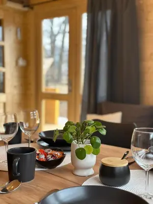a living room with a table and a couch at Domek na Wiejskiej in Zator