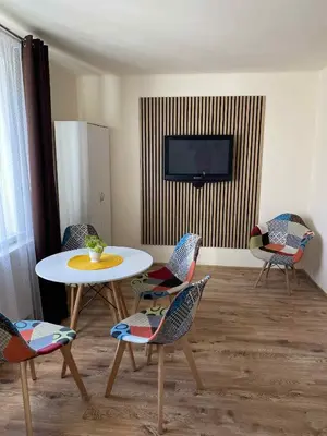 two beds in a room with pictures on the wall at Domek na Wiejskiej in Zator