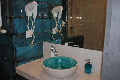 a bathroom with a sink with two hair driers at NATA Pokoje Gościnne Restauracja in Libiąż
