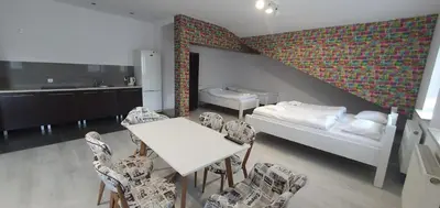 a room with a table and chairs and a bedroom at NATA Pokoje Gościnne Restauracja in Libiąż