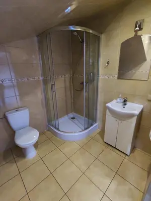 a bathroom with a shower and a toilet and a sink at NATA Pokoje Gościnne Restauracja in Libiąż