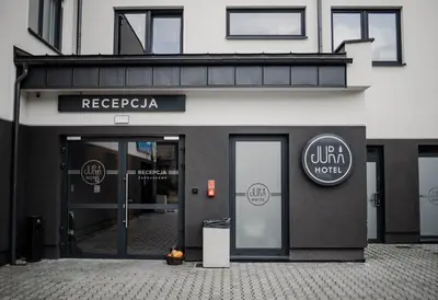 a store front with a sign on the front of a building at Jura Hotel Osiek in Olkusz