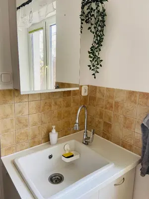 a kitchen with a sink and a mirror at Luxodonta Apartment in Kraków