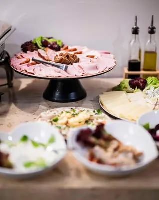 two plates of food on a table with plates of food at Hotel H12**** in Kraków