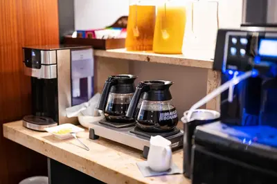 a counter with two coffee pots on a coffee maker at Hotel H12**** in Kraków