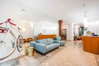 a living room with a couch and a bike at Hotel H12**** in Kraków