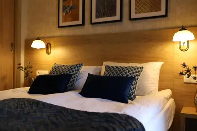 a bedroom with a large white bed with two pillows at Portal House Apartments in Kraków