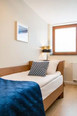 a bedroom with a bed and a window at Portal House Apartments in Kraków