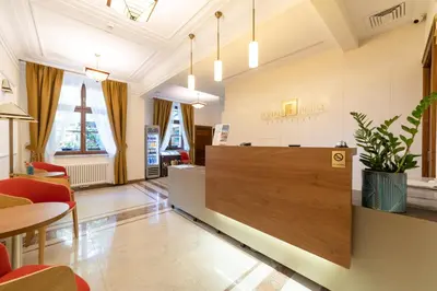 a lobby of a waiting room with a reception desk at Portal House Apartments in Kraków