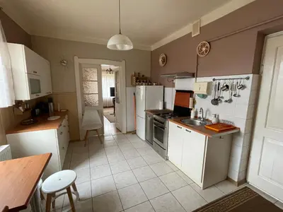 a kitchen with white cabinets and a counter top at Apartament in Bochnia
