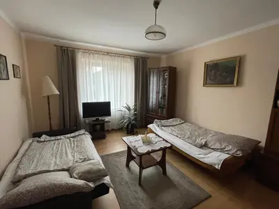 a living room with two beds and a table at Apartament in Bochnia