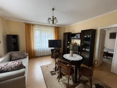 a living room with a table and chairs and a couch at Apartament in Bochnia