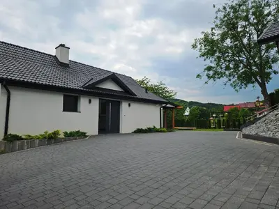 a patio with four chairs and a table and benches at Domek z jacuzzi Cztery Pory Roku in Czchów