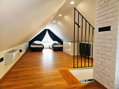a bedroom with a bed and a chair and a mirror at Domek z jacuzzi Cztery Pory Roku in Czchów