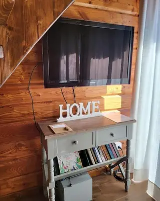 a desk with a tv on top of a wall at Domki na Górniej Łące - Domek Górny in Łazany