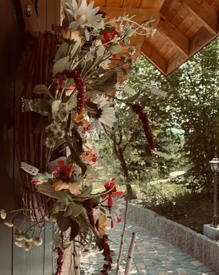 a bunch of flowers hanging from a building at Domki na Górniej Łące - Domek Górny in Łazany